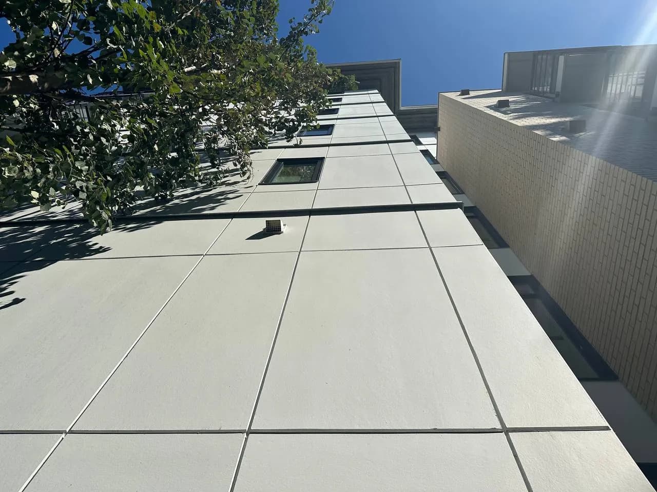 Fiber cement panel siding on a mid-rise building, exterior renovation Surrey BC