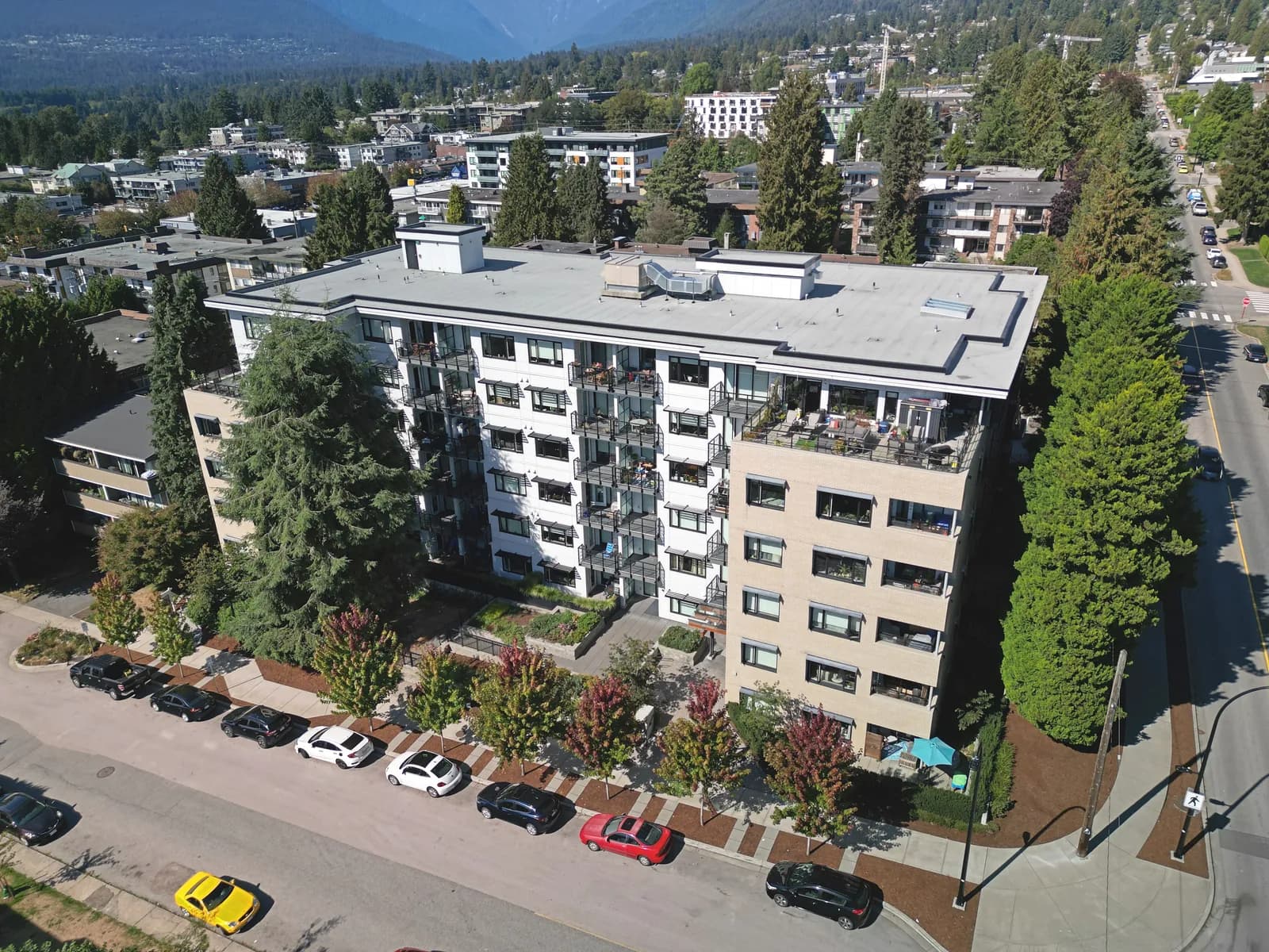 Multi-family mid-rise with North Shore mountain backdrop — BC water damage restoration context