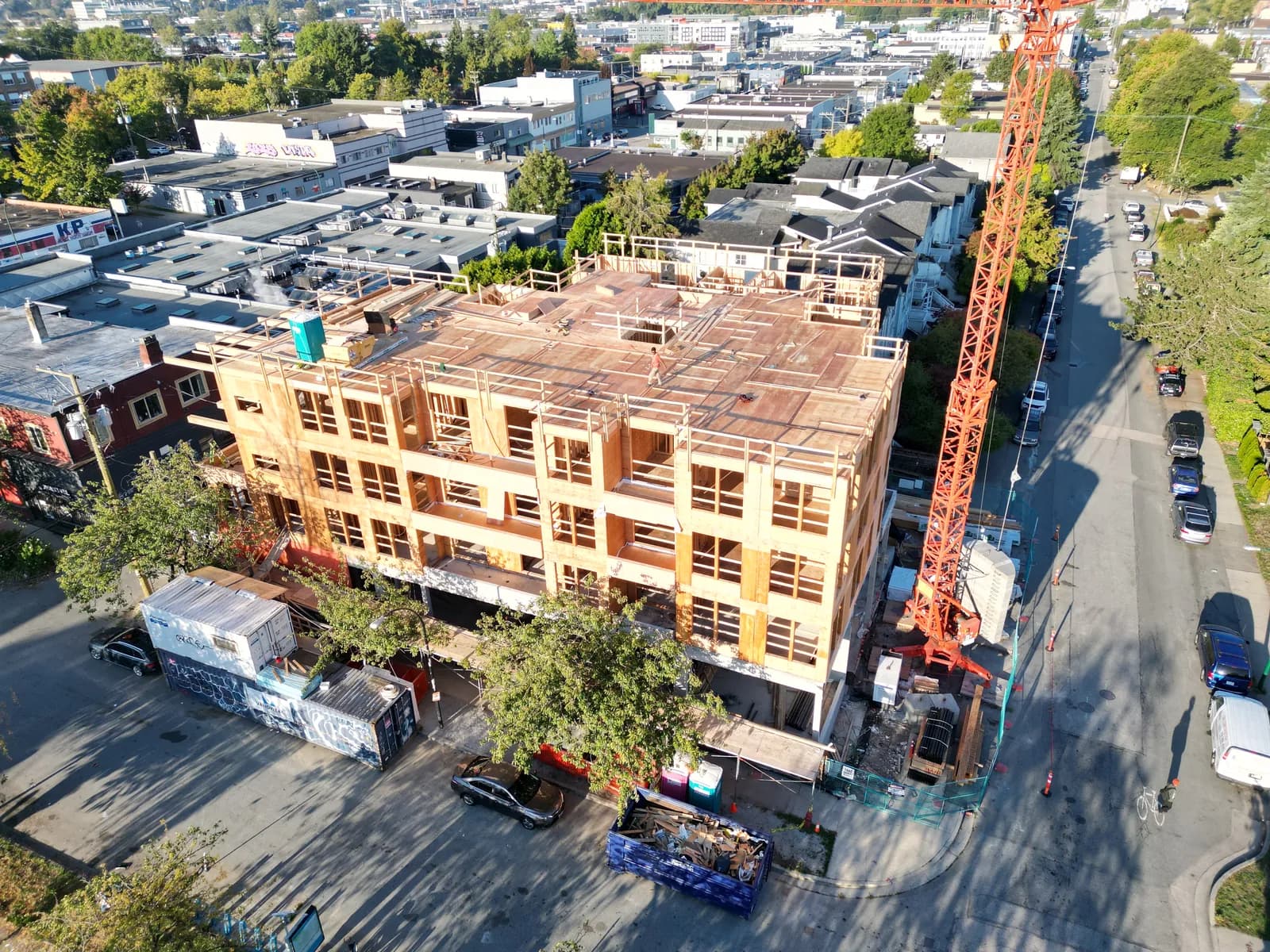Mid-rise wood-frame construction with tower crane — mold remediation Vancouver envelope rebuild